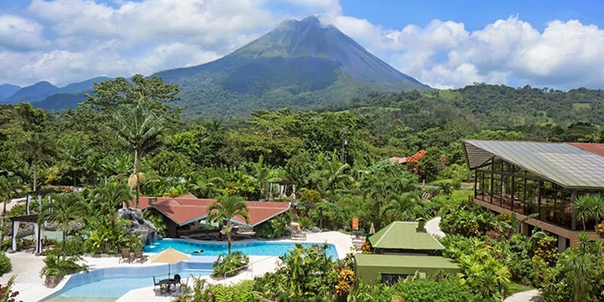 Experience authentic Costa Rican charm and the soothing embrace of thermal hot springs at Arenal Springs Resort and Spa in La Fortuna. Set against the majestic backdrop of Arenal Volcano, this top-rated eco-resort offers not only breathtaking views but also lush tropical gardens and private hot springs for an exclusive retreat. Our friendly and welcoming staff ensure you never forget you're in the heart of Costa Rica, greeting you with warm smiles and providing delightful service. Our resort's amenities cater to all your needs, including thermal hot springs, a rejuvenating spa, adult and kids' swimming pools, Jacuzzi, sun deck, restaurants, pizza and sushi bars, wet bar, souvenir shop, Wi-Fi in select areas, a yoga platform, and a conference room. Plus, when you book your vacation through us, you'll enjoy an extra treat: a special 15% discount per person on spa treatments at Arenal Springs Resort, enhancing your Costa Rican getaway. This offer is only available to Pacific Trade Winds clients!