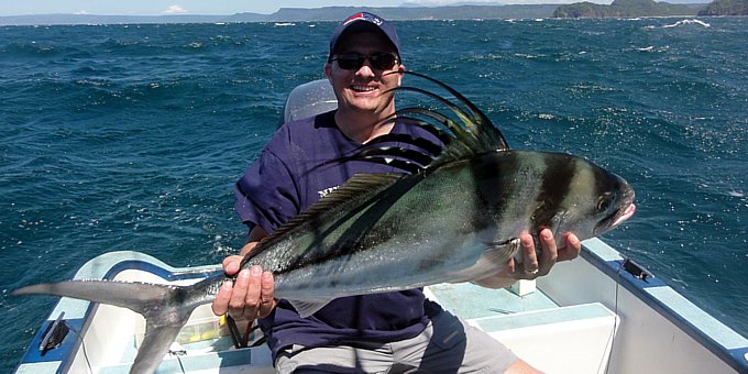 A proud angler holds up a beautiful Roosterfish in Costa Rica!