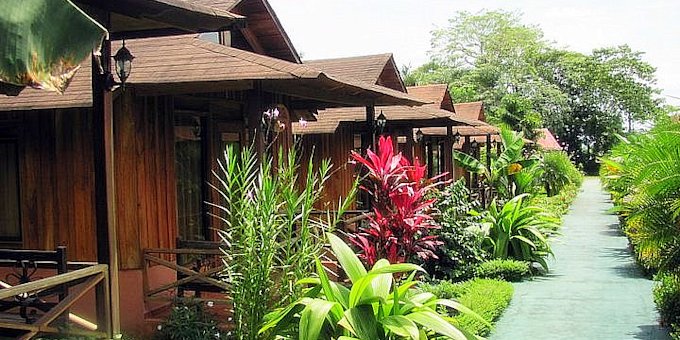 Hotel Arenal Montechiari in La Fortuna, Costa Rica, is an affordable, rustic, and family-friendly hotel positioned on the outskirts of town. The hotel offers comfortable accommodations with a variety of room options to suit different preferences and group sizes. Each room is tastefully decorated and equipped with modern amenities for a comfortable stay. The hotel's lush gardens and outdoor swimming pool create a serene and inviting atmosphere for guests to relax and unwind. The on-site restaurant serves delicious Costa Rican cuisine, offering a delightful culinary experience. The hotel's location provides easy access to explore the nearby Arenal Volcano National Park, hot springs, and a range of adventure activities, including ziplining and hiking. With its warm hospitality, picturesque surroundings, and convenient location, Hotel Arenal Montechiari is an excellent choice for travelers looking to experience the natural wonders of La Fortuna, Costa Rica. Lodge amenities include breakfast, a restaurant, a swimming pool, a wet bar, a concierge, a WI-fi internet connection, laundry service, and tropical gardens.