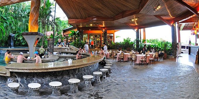 Baldi Hot Springs and Hotel in La Fortuna, Costa Rica, is a renowned destination for relaxation and natural rejuvenation. The hotel is situated in the heart of the Arenal Volcano area and offers comfortable accommodations surrounded by lush tropical gardens. Guests have exclusive access to the Baldi Hot Springs, a series of mineral-rich thermal pools and cascading waterfalls that provide a soothing and therapeutic experience. The pools range in temperature, allowing guests to find their ideal level of relaxation. The hotel features spacious rooms and suites with modern amenities, ensuring a comfortable stay. The on-site restaurant offers a variety of delicious culinary options, including both local and international dishes. With its prime location, guests have easy access to explore the Arenal Volcano National Park, engage in outdoor activities like hiking and zip-lining, and discover the rich biodiversity of the region. Whether seeking relaxation, adventure, or a combination of both, Baldi Hot Springs and Hotel provides a memorable and rejuvenating stay in La Fortuna, Costa Rica. Amenities of the hotel include multiple restaurants and bars, many pools, hot springs, spa, sauna and a cafe Britt store so you can stock up on souvenirs.