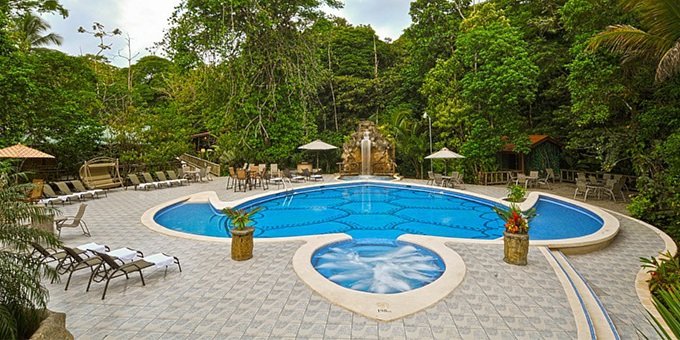 Evergreen Lodge is a charming eco-lodge located in the heart of Tortuguero, Costa Rica. Surrounded by the lush rainforest and bordered by the canals of Tortuguero National Park, this lodge offers a unique and immersive experience in the region's rich biodiversity. The lodge features comfortable and spacious rustic-style cabins that blend harmoniously with the natural surroundings. Each cabin is equipped with modern amenities and offers beautiful views of the rainforest or the canals. Guests can relax and unwind in the lodge's open-air restaurant, enjoying delicious meals made from fresh local ingredients. The lodge also offers a range of activities and tours, including guided boat tours along the canals to spot wildlife, hiking through the rainforest to discover amazing flora and fauna, and visiting the nearby village of Tortuguero to learn about the local culture and history. Evergreen Lodge is committed to sustainability and conservation, and guests can learn about the lodge's efforts to protect the environment and support the local community. With its tranquil setting, abundant wildlife, and commitment to eco-tourism, Evergreen Lodge provides a memorable and authentic experience in Tortuguero. The Lodge features a network of above ground walkways linking the well-appointed, cabina style rooms to common areas such as the swimming pool, spa, bar and open-air restaurant. There is no television or air conditioning. All meals are provided throughout your stay and bilingual tour guides can take you ziplining over the forest canopy. A daily itinerary of nature and cultural tour activities are included. NOTE: There is a 25-pound weight limit per person for luggage brought in by boat or plane. All visitors to the region must pay the entrance fee to the national park, which is $15 per adult, $5 per child between the ages of 5 - 11, and free for children 4 years or less. The entrance fee must be paid in person upon arrival to Tortuguero and is not included in your stay at the lodge.