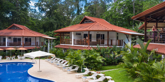 Terrazas del Caribe in Puerto Viejo, Costa Rica, is a charming hotel offering comfortable accommodations, warm hospitality, and a tropical ambiance. The well-appointed apartments and rooms feature essential amenities, and some offer rainforest or pool views. Guests can relax in the lush tropical gardens or take a refreshing dip in the swimming pool. The onsite restaurant serves delicious local and international cuisine. The hotel's ideal location allows easy access to the beautiful beaches and vibrant town center of Puerto Viejo, both of which are a long walk or a short bike ride away. Terrazas del Caribe is the perfect choice for a memorable stay in this vibrant coastal destination. Hotel amenities include a restaurant and bar, tropical gardens, a swimming pool, jacuzzi, parking, and WiFi in some common areas. <strong>Please note that Pacific Trade Winds has a price match guarantee for this hotel at the time of booking.</strong>