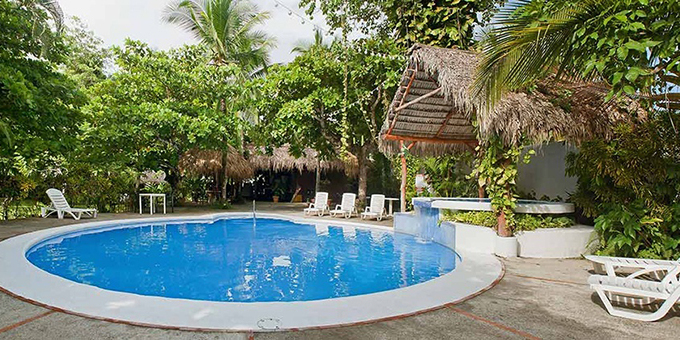Enjoy easy beach access and warm tropical vibes at the Hotel Karahe in Manuel Antonio. This affordable and budget-friendly hotel is set at the base of the hill in Manuel Antonio and is spread out in two sections, one on each side of the main road. Hotel amenities include beach access from the beach side of the property, an open-air seaside restaurant, swimming pool, tropical gardens, and WiFi in some areas.