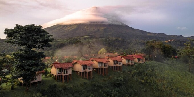 Hotel Montana de Fuego in La Fortuna, Costa Rica, is a charming and picturesque retreat nestled in the heart of the Arenal Volcano region. Surrounded by lush tropical gardens and offering stunning views of the volcano, this hotel provides a tranquil and immersive experience in nature. The comfortable and spacious rooms and bungalows are thoughtfully designed to blend harmoniously with the natural surroundings, providing a cozy and inviting atmosphere for guests. The hotel features a beautiful outdoor pool and hot springs, allowing guests to relax and soak in the therapeutic mineral-rich waters while enjoying the serene ambiance. The on-site restaurant serves delicious local and international cuisine, using fresh ingredients sourced from the region. The hotel's convenient location provides easy access to explore the nearby Arenal Volcano National Park and engage in a variety of outdoor activities, such as hiking, ziplining, and horseback riding. With its warm hospitality, peaceful setting, and proximity to natural wonders, Hotel Montana de Fuego offers a memorable stay for guests seeking tranquility and adventure in La Fortuna, Costa Rica. Other hotel amenities include tropical gardens, restaurant and bar, swimming pool, spa and wellness center, and WiFi in some areas.