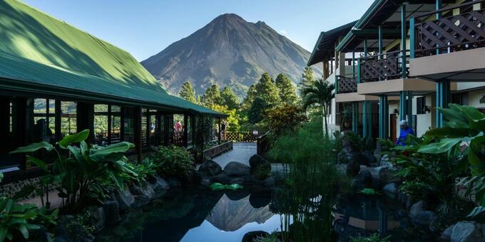 Arenal Observatory Lodge in El Castillo, Costa Rica, is a unique and enchanting retreat located within the Arenal Volcano National Park. Surrounded by lush rainforest and offering unobstructed views of the majestic Arenal Volcano, this lodge provides a truly immersive and awe-inspiring experience. The comfortable rooms and cabins are designed to blend harmoniously with the natural surroundings and provide a peaceful and comfortable stay. Guests can explore the extensive network of hiking trails that wind through the forest, offering opportunities to spot wildlife and witness the volcano from varying angles. The lodge's observatory deck provides a prime vantage point to marvel at the old volcanic eruptions and lava flows (the volcano no longer erupts). The on-site restaurant serves delicious meals with an emphasis on local and sustainable ingredients. With its prime location, rich biodiversity, and breathtaking views, Arenal Observatory Lodge offers a truly unforgettable and immersive experience in El Castillo, Costa Rica. Guests of Arenal Observatory Lodge will enjoy amenities such as swimming pool, internet access, restaurant, bar, tropical gardens, waterfall, wonderful birding, and nature trails.