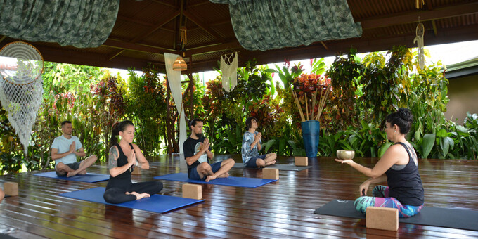 A small group practicing yoga at Arenal Springs Resort