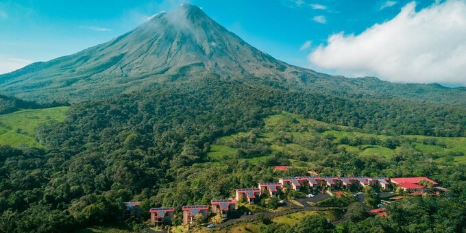 Arenal Kioro Hotel in La Fortuna, Costa Rica, is a luxurious and modern hotel that offers a delightful experience amidst the stunning natural beauty of the Arenal Volcano region. The hotel's contemporary design and comfortable accommodations provide a relaxing atmosphere for guests. The spacious rooms and suites are elegantly appointed and feature modern amenities to ensure a pleasant stay. Guests can indulge in the hotel's thermal hot springs pools, which offer rejuvenating and therapeutic experiences. The on-site restaurant serves delectable dishes that showcase the flavors of Costa Rican cuisine, and the bar provides a cozy setting to unwind and enjoy a refreshing drink. With its central location, guests have easy access to explore the nearby Arenal Volcano National Park, waterfalls, and adventure activities. The attentive and friendly staff go above and beyond to provide exceptional service, ensuring that guests have a memorable and enjoyable stay at Hotel Royal Corin in La Fortuna, Costa Rica. Guests of Arenal Kioro will enjoy amenities such as hot springs pools, a mini gym, an outdoor swimming pool, a children’s pool, a gift shop, Spa Tub, laundry service, a safety deposit box at the front desk, air-conditioned public areas, full-service spa, two restaurants, room service and parking.