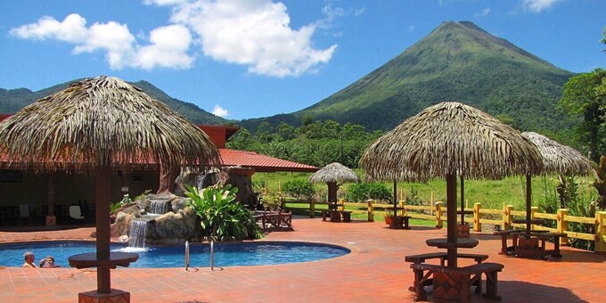 Hotel La Pradera in La Fortuna, Costa Rica, is a charming and cozy budget-friendly hotel nestled in the lush tropical landscape. The hotel offers affordable accommodations with a range of room options to suit different preferences and budgets. Each room is tastefully decorated and equipped with modern amenities for a pleasant stay. Guests can relax and unwind in the hotel's beautiful gardens or take a refreshing dip in the outdoor pool. The hotel's friendly and attentive staff are dedicated to ensuring a memorable stay for guests, offering assistance and providing valuable recommendations for exploring the natural wonders of La Fortuna, including the famous Arenal Volcano and hot springs. Hotel La Pradera is an ideal choice for economically-focused travelers seeking a comfortable and convenient base to explore the stunning natural beauty of La Fortuna, Costa Rica. Hotel amenities include a swimming pool and Jacuzzi, tropical gardens, and free WiFi. The restaurant is closed for lunch and dinner, but complimentary breakfast will be provided.