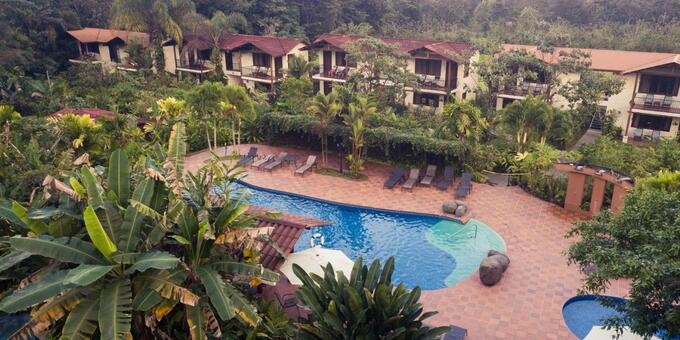 Casa Luna Lodge in La Fortuna, Costa Rica, is a charming eco-lodge surrounded by lush rainforest and breathtaking views of the Arenal Volcano. The lodge offers rustic yet comfortable accommodations, including cozy rooms, blending harmoniously with the natural surroundings. Guests can relax and enjoy the serene ambiance from their balconies or terraces. The lodge features a lovely outdoor swimming pool, perfect for a refreshing dip, and beautifully landscaped gardens that attract an array of colorful birds and wildlife. The on-site restaurant serves delicious Costa Rican cuisine, prepared with fresh local ingredients. Guests can also indulge in rejuvenating spa treatments or explore the nearby natural attractions, such as Arenal Volcano National Park and hot springs. With its commitment to sustainability and connection to nature, Casa Luna Lodge offers a tranquil and immersive experience, allowing guests to truly unwind and reconnect with the beauty of La Fortuna, Costa Rica. Lodge amenities include  WiFi, AC, restaurant, pool, laundry, safety deposit, and parking.