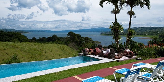 La Mansion Inn Arenal is an exclusive, quiet and relaxing small luxury boutique hotel resort set on 25 acres overlooking scenic Lake Arenal on the other end of the lake from Arenal Volcano in La Fortuna, Costa Rica. Hotel amenities include restaurant, bar, swimming pool, jacuzzi, WiFi in the common areas, and pool table. The individual cottages have been upgraded recently, and feature tropical wall paintings by famous Costa Rican artists. Several room styles have private hot tubs.