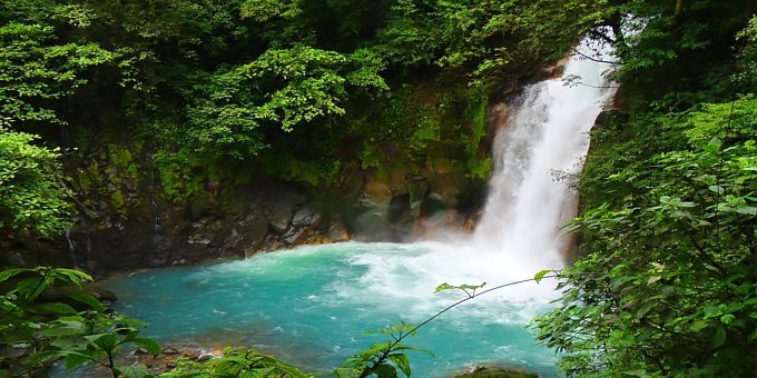 The beautiful Rio Celeste Waterfall is inside of Tenorio Volcano National Park