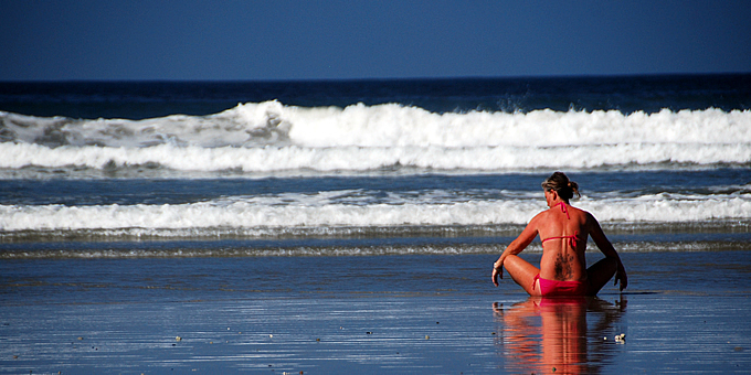 A woman sitting on the beach in Nosara