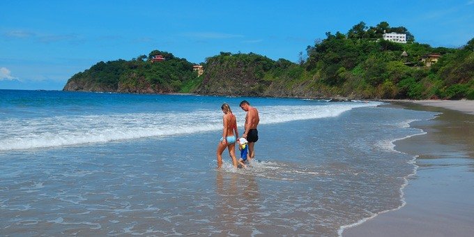 A family enjoys beach time in Playa Flamingo